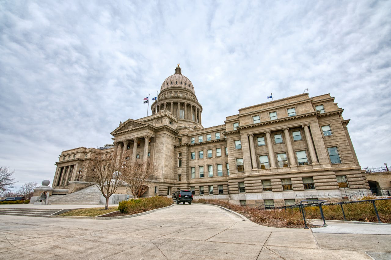 Majestic view of the Idaho State Capitol with its iconic dome under a cloudy sky.