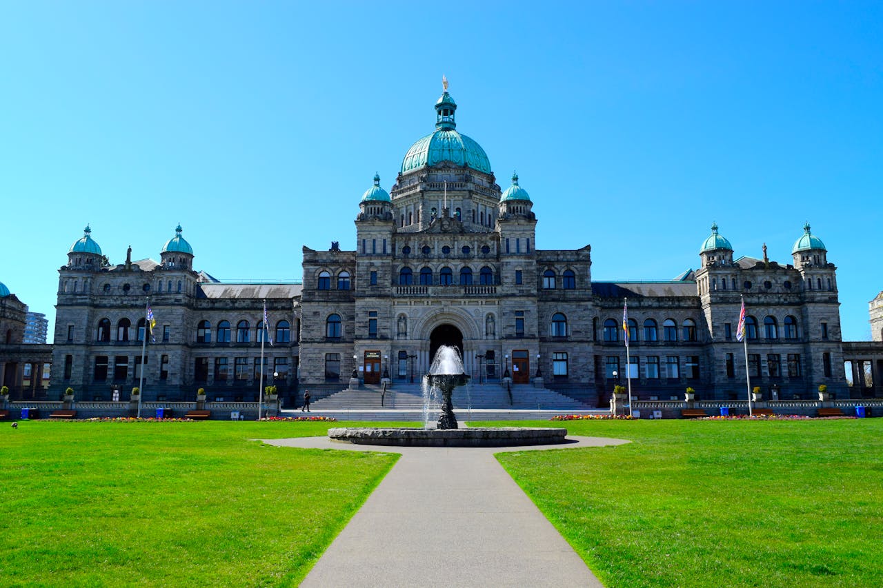 Stunning view of the British Columbia Parliament Building with clear blue sky.